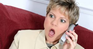 Shocked Business Woman On Cordless Phone