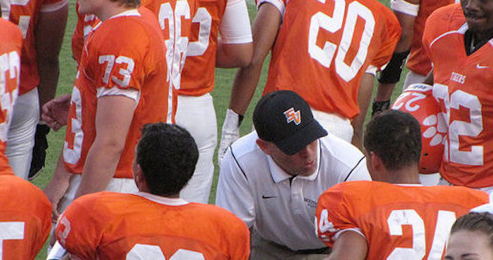 football coach talking to a player