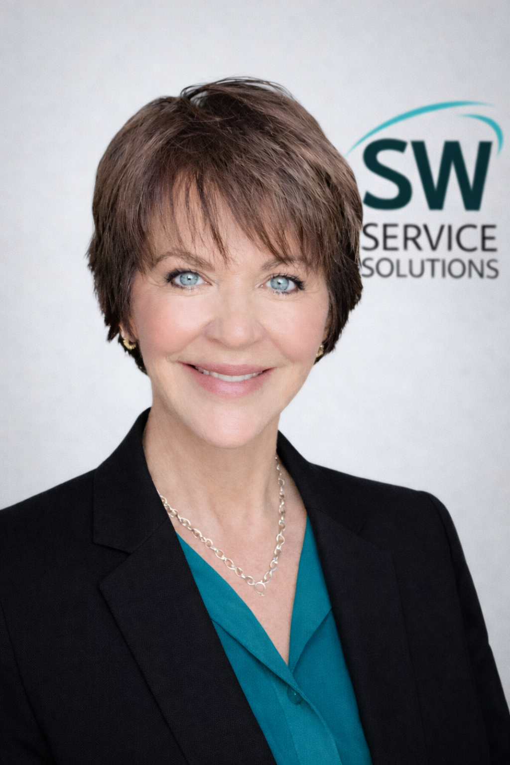 Professional business headshot with teal blouse