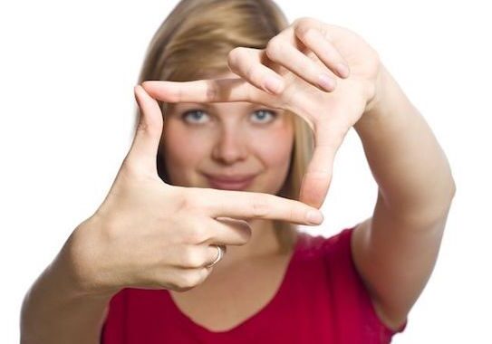 Woman framing face with her hands.