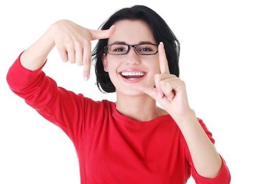 Woman in red shirt making a frame.