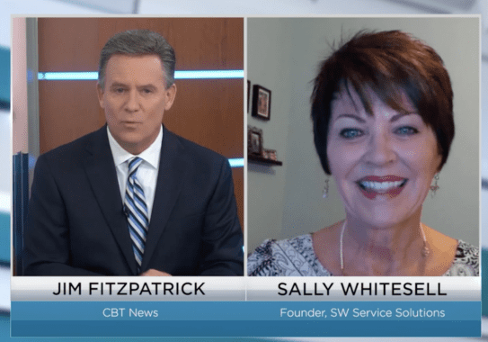 Two people in a televised interview.