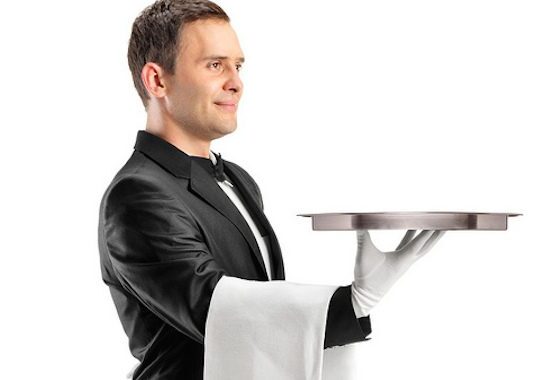 Butler holding a silver tray, gloves on.