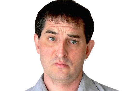 Confused man with raised eyebrow expression.